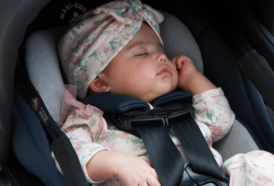 baby sleeping in cozy car seat