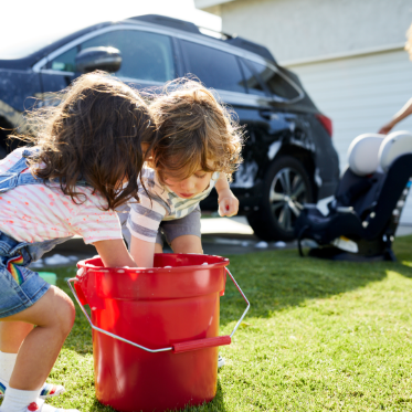 children playing washing cars outside